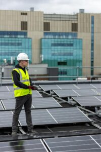 Engineer on a roof fitting solar panels